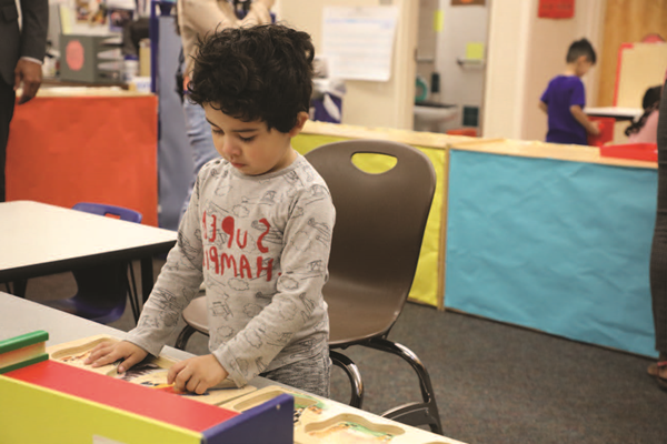 Preschool student doing a math activity at a table